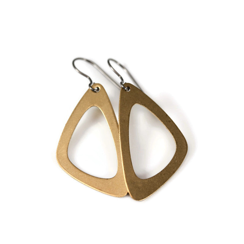 A pair of scalene triangle dangle earrings with a raw brass finish, displayed on a white background.