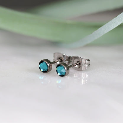 Titanium stud earrings, bezel set crystals, teal green