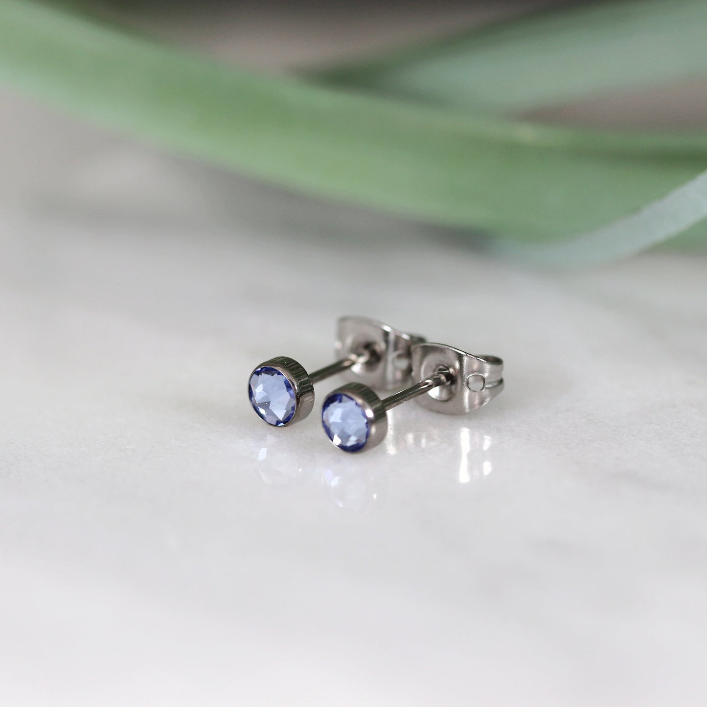 Titanium stud earrings, bezel set crystals, sky blue