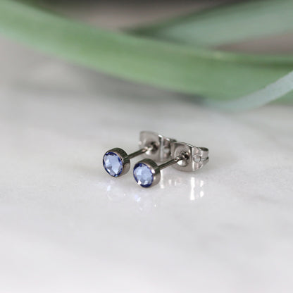 Titanium stud earrings, bezel set crystals, sky blue