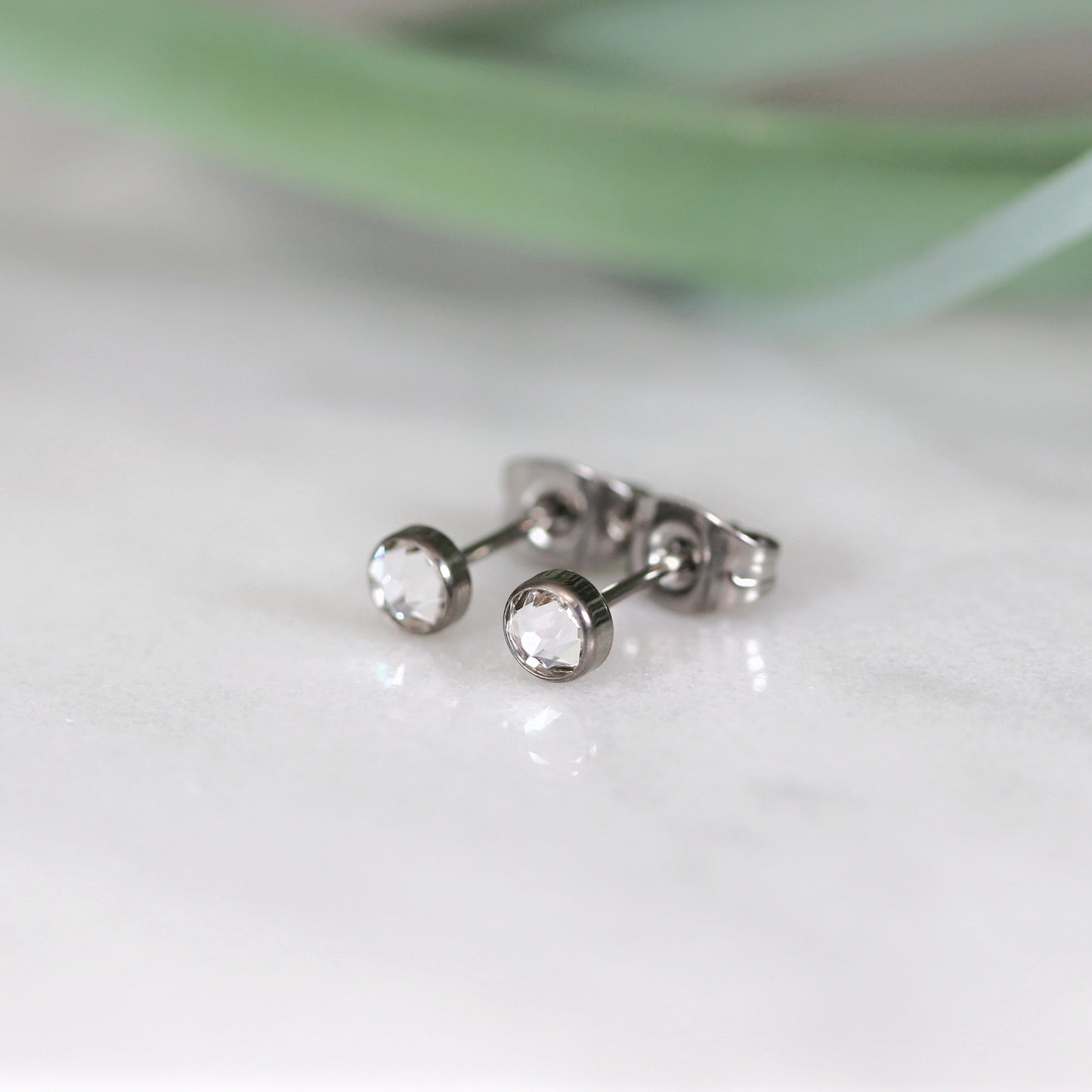 Titanium stud earrings, bezel set crystals, clear