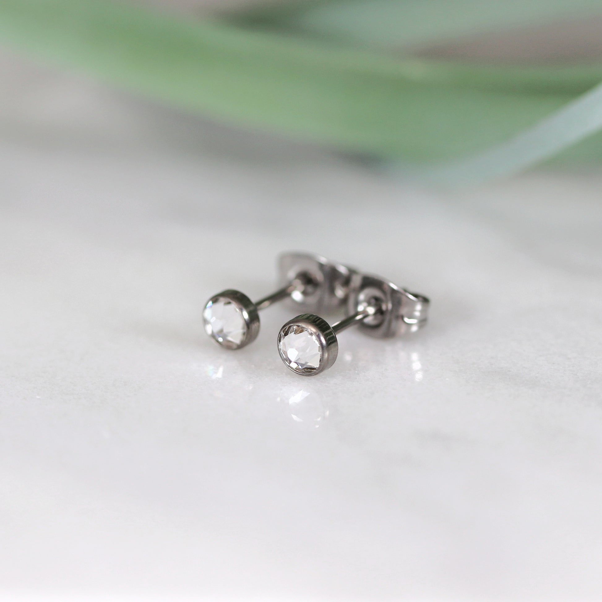 Titanium stud earrings, bezel set crystals, clear