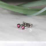 Titanium stud earrings, bezel set crystals, rose pink