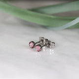 Titanium stud earrings, bezel set crystals, pink