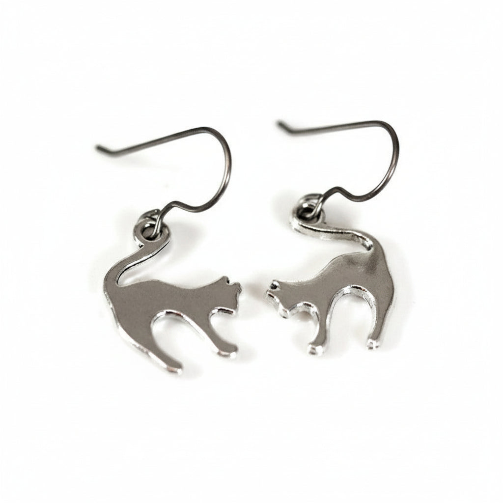 A pair of silver stainless steel cat dangle earrings with a plastic hook.