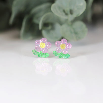 A set of colorful flower stem stud earrings displayed in a row, with colors including pink, blue, green, and yellow.