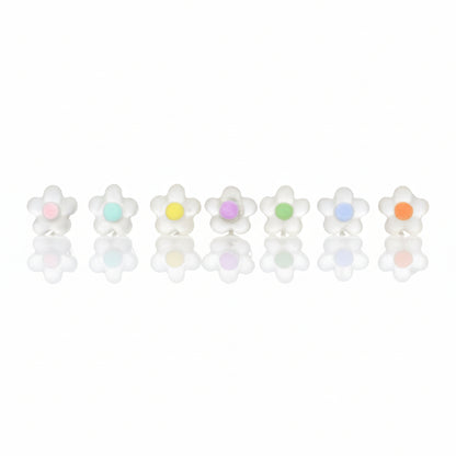 A collection of dainty dot flower stud earrings in various colors, set against a neutral background.