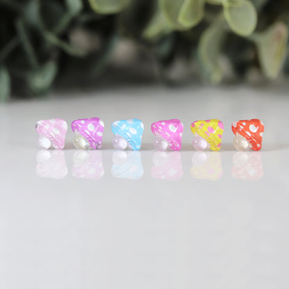 colorful mushroom earrings in a row