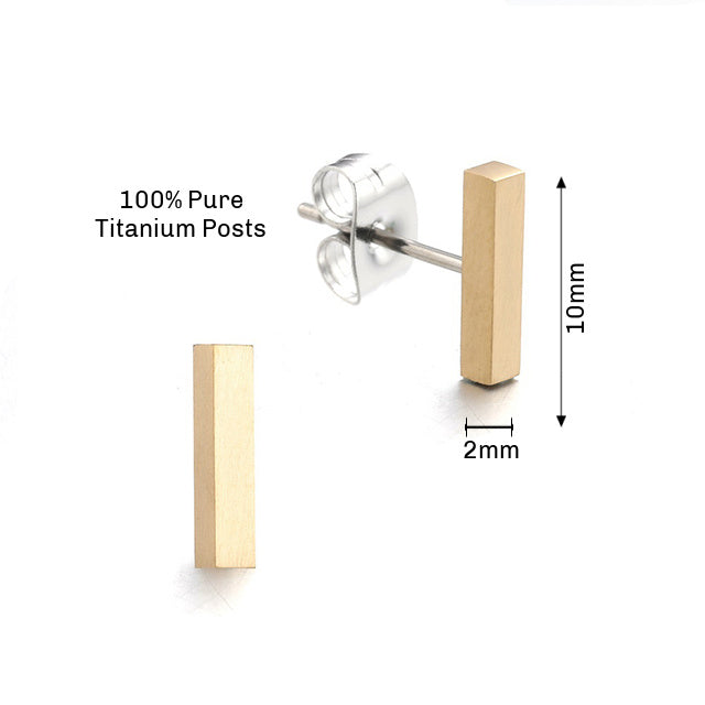 A pair of gold titanium bar stud earrings with butterfly back closures.
