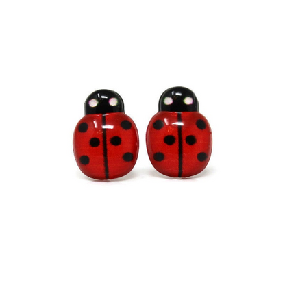 A pair of red ladybug stud earrings with black spots, designed for pierced ears with various post styles.