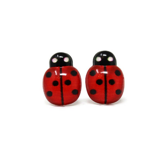 A pair of red ladybug stud earrings with black spots, designed for pierced ears with various post styles.