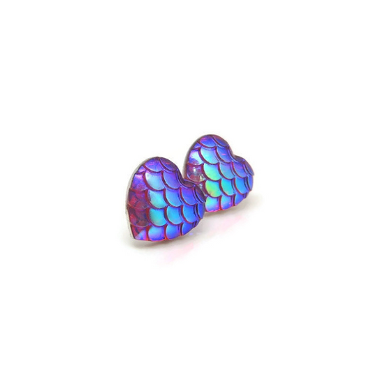 A pair of multicolored heart-shaped mermaid scale stud earrings made of resin.