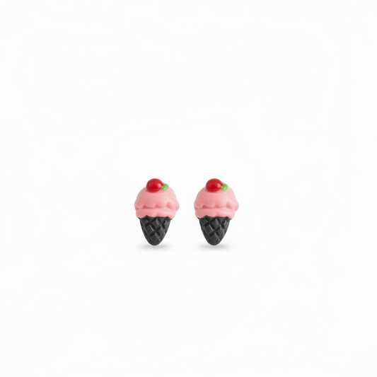 A pair of pink ice cream cone stud earrings held between fingers, with the cone design and a single pink scoop on top.