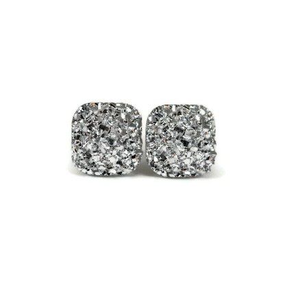 A pair of silver square druzy stud earrings with rounded corners on a white background, with a text overlay saying 'More Colors'.